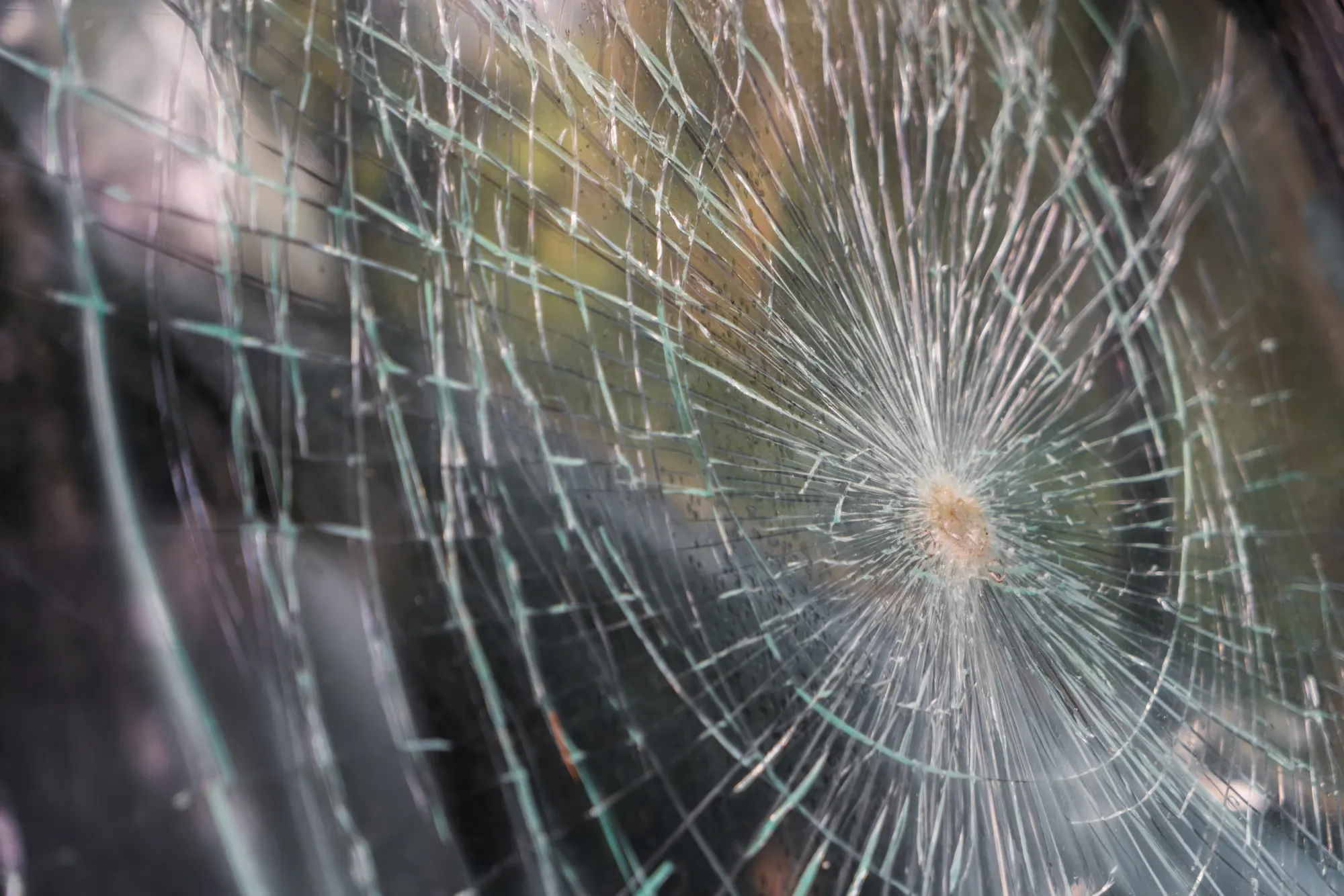 Broken or cracked window glass showing shattered patterns Broken or cracked window glass showing shattered patterns