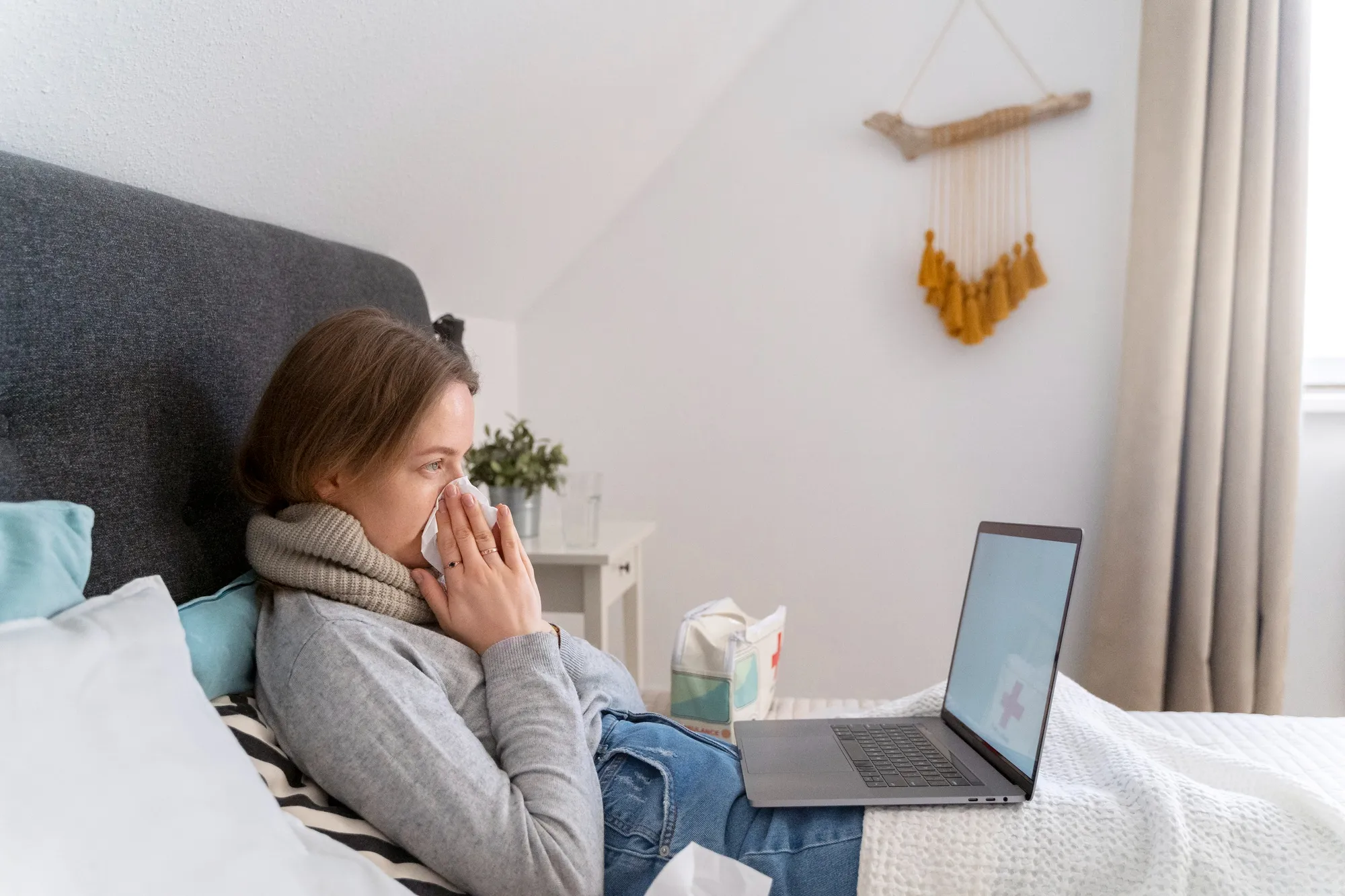 Person sneezing inside due to indoor humidity and cold window Person sneezing inside due to indoor humidity and cold window