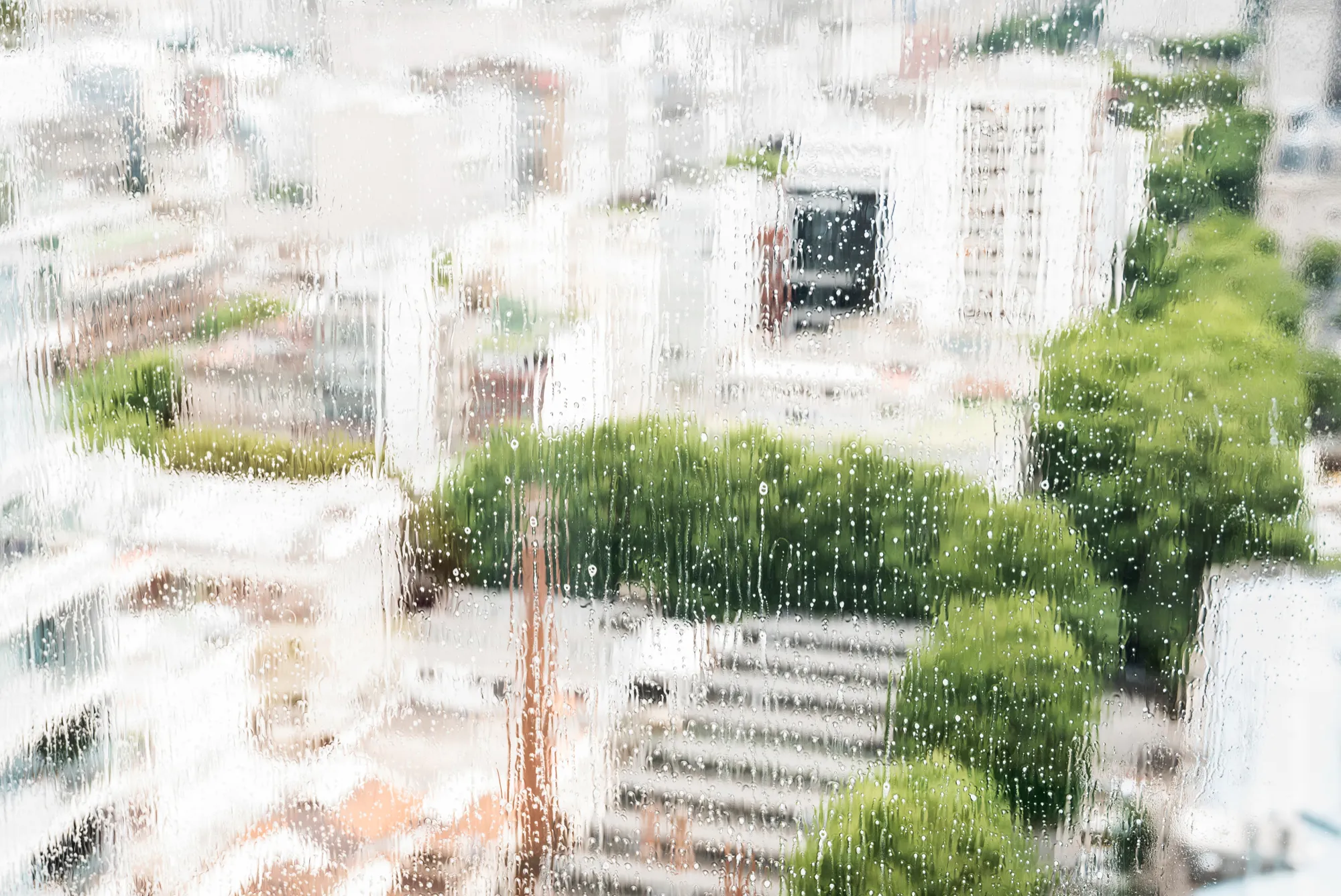 Water droplets on window glass from exteriorr moisture buildup Water droplets on window glass from exteriorr moisture buildup